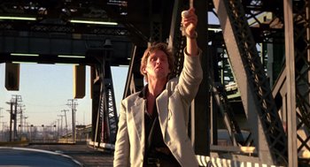 Movie still from “52 Pick-Up” (1986), directed by John Frankenheimer – A woman holding a key in her hand; Medium shot, Low angle