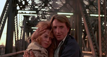 Movie still from “52 Pick-Up” (1986), directed by John Frankenheimer – A man and a woman are posing for a picture; Close Up shot, Low angle