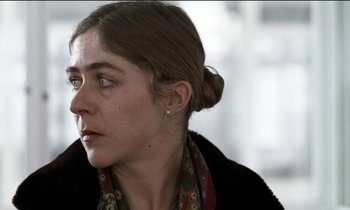 Movie still from “71 Fragments of a Chronology of Chance” (1994), directed by Michael Haneke – A person wearing a jacket; Close Up shot, Low angle