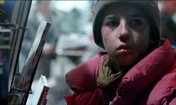 Movie still from “71 Fragments of a Chronology of Chance” (1994), directed by Michael Haneke – A young boy wearing a red jacket and a hat; Close Up shot, Low angle