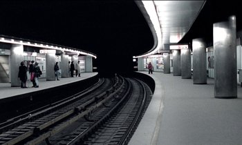 Movie still from “71 Fragments of a Chronology of Chance” (1994), directed by Michael Haneke – People are standing on the tracks of a train station; Extreme Wide shot, High angle