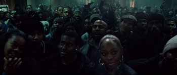 Movie still from “8 Mile” (2002), directed by Curtis Hanson – A group of people standing in a dark room; Medium shot, High angle