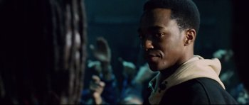 Movie still from “8 Mile” (2002), directed by Curtis Hanson – A person with a microphone in a dark room; Close Up shot, Over the shoulder angle