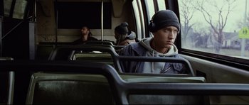 Movie still from “8 Mile” (2002), directed by Curtis Hanson – A group of people riding on a bus together; Medium shot, High angle