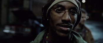 Movie still from “8 Mile” (2002), directed by Curtis Hanson – A person wearing glasses and a hat; Close Up shot, Low angle