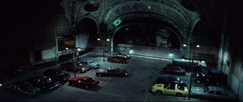 Movie still from “8 Mile” (2002), directed by Curtis Hanson – Cars are parked in a parking lot at night; Extreme Wide shot, High angle