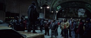 Movie still from “8 Mile” (2002), directed by Curtis Hanson – A group of people standing around a statue of a man; Wide shot, Low angle