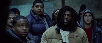 Movie still from “8 Mile” (2002), directed by Curtis Hanson – A group of men standing next to each other; Medium shot, Low angle