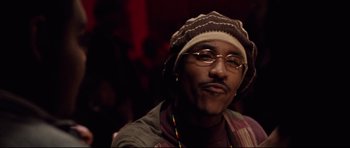 Movie still from “8 Mile” (2002), directed by Curtis Hanson – A person wearing glasses and a hat; Close Up shot, Low angle