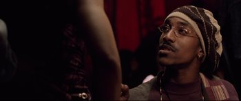 Movie still from “8 Mile” (2002), directed by Curtis Hanson – A man with glasses is looking at a woman; Close Up shot, Over the shoulder angle