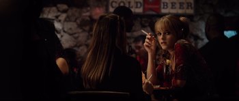 Movie still from “8 Mile” (2002), directed by Curtis Hanson – Two women sitting at a table in front of a brick wall; Close Up shot, Over the shoulder angle