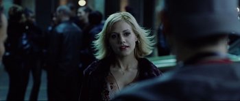 Movie still from “8 Mile” (2002), directed by Curtis Hanson – A woman with blonde hair is standing in a crowd of people; Close Up shot, Over the shoulder angle