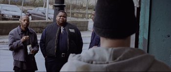 Movie still from “8 Mile” (2002), directed by Curtis Hanson – Two men standing next to each other on the sidewalk; Medium shot, Over the shoulder angle