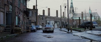 Movie still from “8 Mile” (2002), directed by Curtis Hanson – A car parked on the side of the road in the rain; Extreme Wide shot, High angle