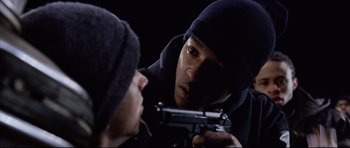 Movie still from “8 Mile” (2002), directed by Curtis Hanson – A man holding a gun in front of another man; Close Up shot, Over the shoulder angle