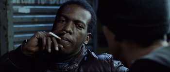 Movie still from “8 Mile” (2002), directed by Curtis Hanson – A man smoking a cigarette while looking into the camera; Close Up shot, Low angle