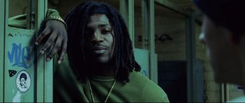 Movie still from “8 Mile” (2002), directed by Curtis Hanson – A person with dreads wearing a green shirt; Close Up shot, Low angle