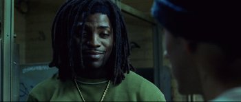 Movie still from “8 Mile” (2002), directed by Curtis Hanson – A person with dreadlocks wearing a green shirt; Close Up shot, Low angle