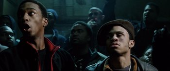 Movie still from “8 Mile” (2002), directed by Curtis Hanson – A group of men standing next to each other in a dark room; Close Up shot, Low angle
