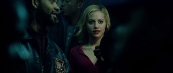 Movie still from “8 Mile” (2002), directed by Curtis Hanson – A woman with red lipstick standing next to other people; Close Up shot, Over the shoulder angle