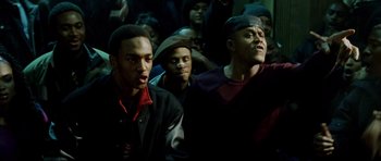Movie still from “8 Mile” (2002), directed by Curtis Hanson – A group of young men standing next to each other in a room; Medium shot, High angle