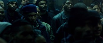 Movie still from “8 Mile” (2002), directed by Curtis Hanson – A group of men standing next to each other in a dark room; Medium shot, High angle