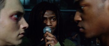Movie still from “8 Mile” (2002), directed by Curtis Hanson – A man holding a microphone up to his face; Close Up shot, Low angle
