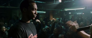 Movie still from “8 Mile” (2002), directed by Curtis Hanson – A man standing in front of a crowd of people; Medium shot, Over the shoulder angle