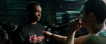 Movie still from “8 Mile” (2002), directed by Curtis Hanson – A man is being interviewed in front of an audience; Medium shot, Over the shoulder angle