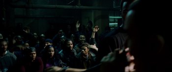 Movie still from “8 Mile” (2002), directed by Curtis Hanson – A group of people sitting in a dark room; Medium shot, Over the shoulder angle