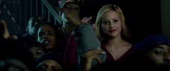 Movie still from “8 Mile” (2002), directed by Curtis Hanson – A group of people sitting in front of each other at night; Medium shot, Over the shoulder angle