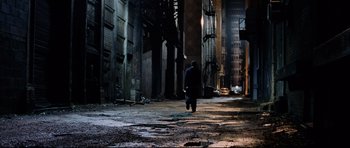 Movie still from “8 Mile” (2002), directed by Curtis Hanson – A man walking down a street in a dark city; Extreme Wide shot, High angle