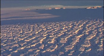 Movie still from “9 Songs” (2004), directed by Michael Winterbottom – A view of a mountain range from a plane window; Extreme Wide shot, High angle