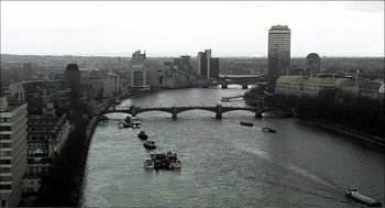 Movie still from “9 Songs” (2004), directed by Michael Winterbottom – A view of a river with many boats on it; Extreme Wide shot, High angle