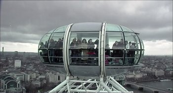Movie still from “9 Songs” (2004), directed by Michael Winterbottom – A group of people standing on top of a ferris wheel; Extreme Wide shot, Low angle