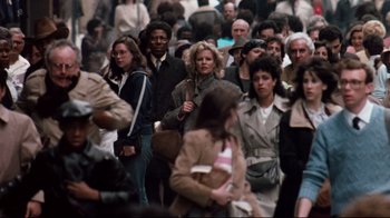 Movie still from “9½ Weeks” (1986), directed by Adrian Lyne – A crowd of people walking down a street; Wide shot, High angle