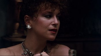 Movie still from “9½ Weeks” (1986), directed by Adrian Lyne – A person wearing a necklace and earrings; Close Up shot, Over the shoulder angle