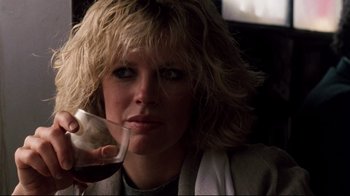 Movie still from “9½ Weeks” (1986), directed by Adrian Lyne – A woman holding a glass of red wine in her right hand; Close Up shot, Low angle