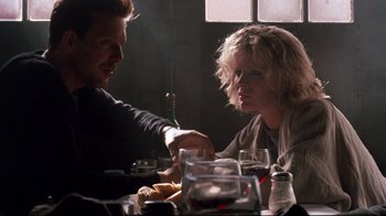 Movie still from “9½ Weeks” (1986), directed by Adrian Lyne – A man and a woman sitting at a dinner table; Close Up shot, Over the shoulder angle