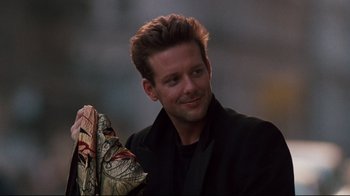 Movie still from “9½ Weeks” (1986), directed by Adrian Lyne – A person holding an umbrella; Close Up shot, Over the shoulder angle