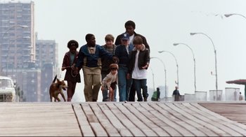 Movie still from “9½ Weeks” (1986), directed by Adrian Lyne – A group of young people walking down a sidewalk; Wide shot, Low angle