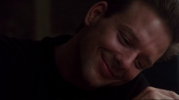 Movie still from “9½ Weeks” (1986), directed by Adrian Lyne – A man smiling for the camera; Close Up shot, Low angle