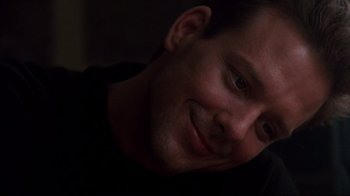 Movie still from “9½ Weeks” (1986), directed by Adrian Lyne – A man smiling for the camera; Close Up shot, Low angle