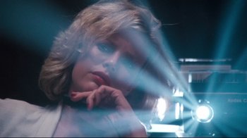 Movie still from “9½ Weeks” (1986), directed by Adrian Lyne – A young woman with her hand under her chin; Close Up shot, Low angle