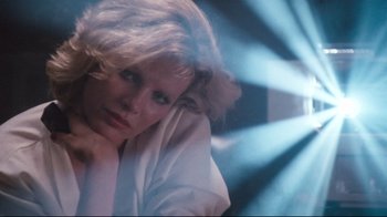 Movie still from “9½ Weeks” (1986), directed by Adrian Lyne – A woman with blonde hair sitting in a room; Close Up shot, Low angle