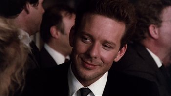 Movie still from “9½ Weeks” (1986), directed by Adrian Lyne – A person wearing a suit and tie; Close Up shot, Over the shoulder angle