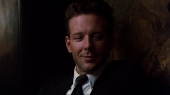 Movie still from “9½ Weeks” (1986), directed by Adrian Lyne – A person wearing a suit and tie; Close Up shot, Low angle