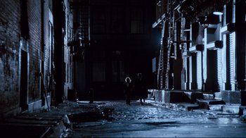 Movie still from “9½ Weeks” (1986), directed by Adrian Lyne – Two people walking down a dark street at night; Extreme Wide shot, High angle