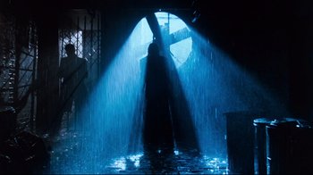 Movie still from “9½ Weeks” (1986), directed by Adrian Lyne – A person standing in a tunnel with a light shining on them; Wide shot, Low angle