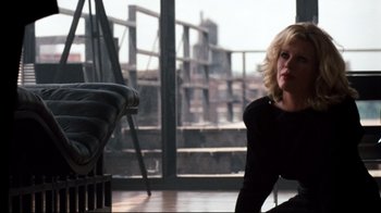 Movie still from “9½ Weeks” (1986), directed by Adrian Lyne – A woman sitting on a chair in front of a window; Medium shot, Low angle